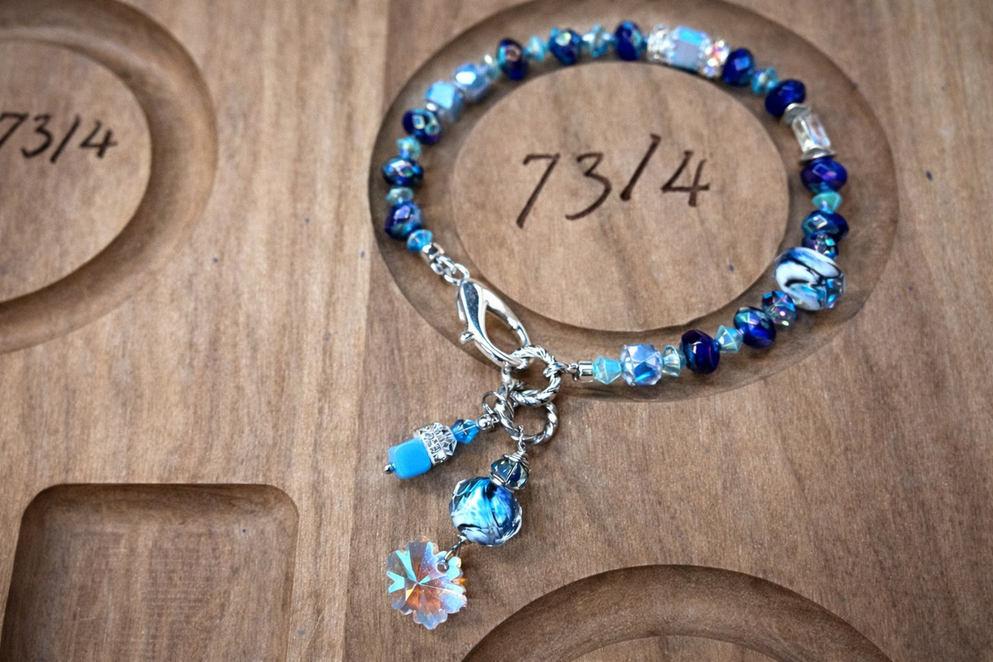 Handcrafted blue beaded bracelet with crystal and silver charm details